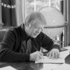 President Jimmy Carter annotates a document while working at his desk in the Oval Office