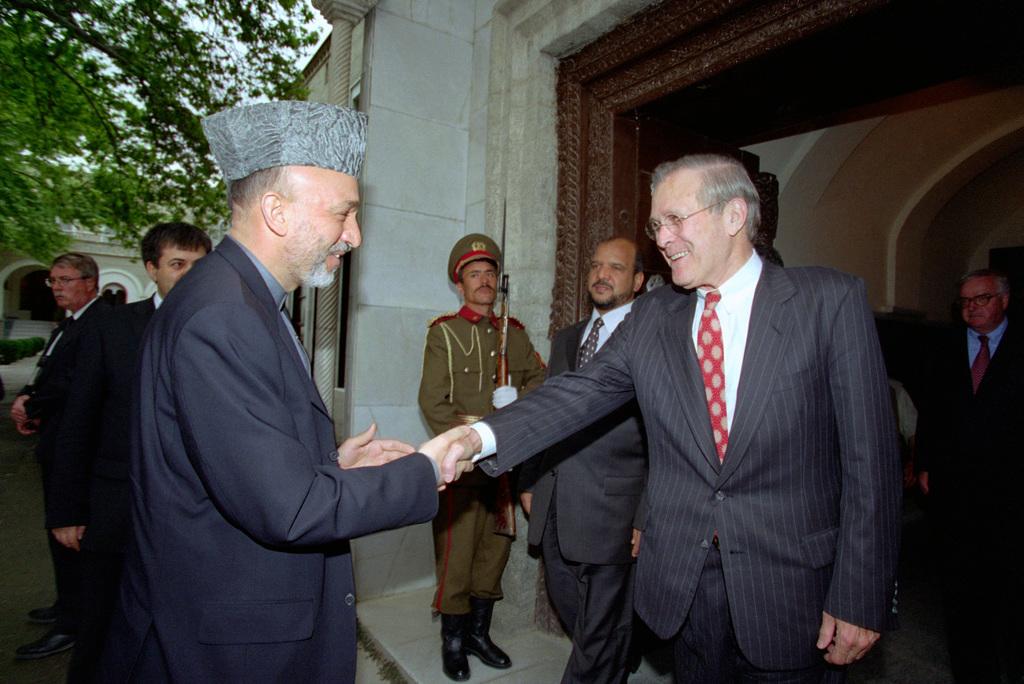 Democratic Republic of Afghanistan President Hamid Karzai (left), shakes hands and greets U.S. Secretary of Defense Donald H. Rumsfeld, as he arrives at the Presidential Palace in Kabul, Afghanistan on May 1, 2003