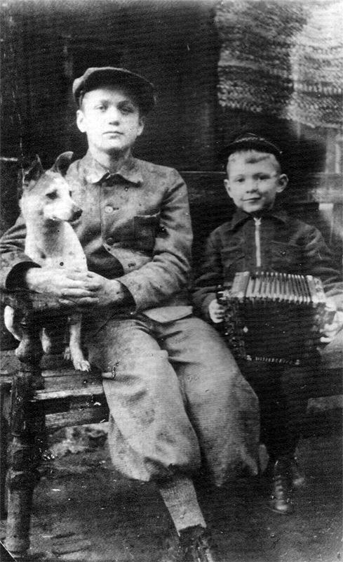 Young Yuri Orlov holding accordian with his cousin Vladimir and dog Jack.