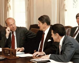 Secretary of State George Shultz (left), President Reagan (center) and Secretary of Defense Caspar Weinberger.
