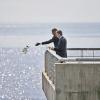 Barack Obama throws flowers in the River Plate