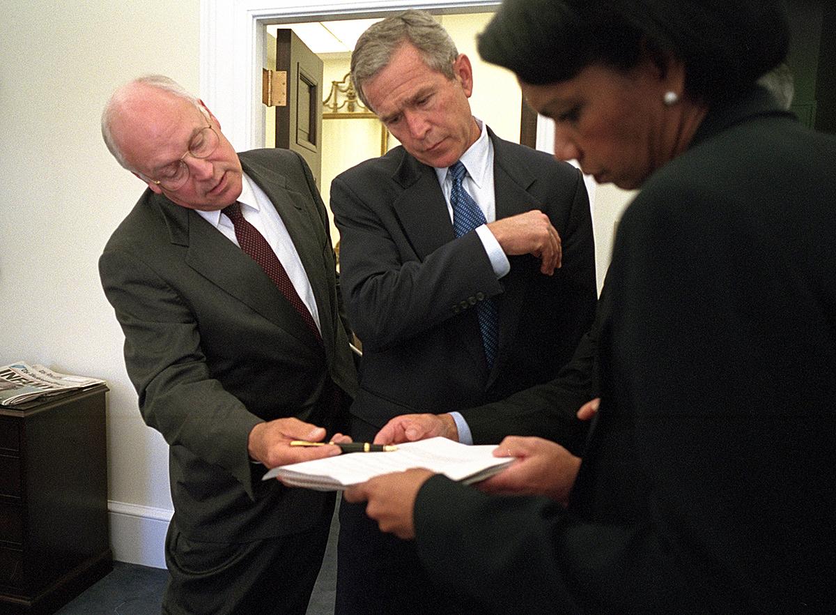 -	On September 12, 2001, President George W. Bush (center) looks over a briefing paper on the previous day’s attacks with Vice President Richard Cheney and National Security Advisor Condoleezza Rice outside the Oval Office 