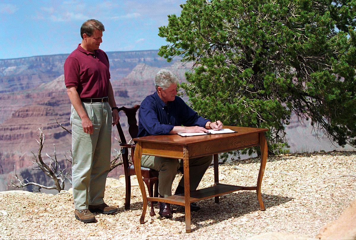 President Clinton, sitting at a desk on the edge of the Grand Canyon in September 1996