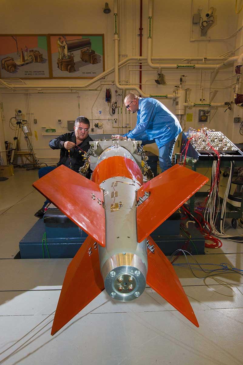 Sandia National Laboratories technologists install instrumentation on a test unit for the latest B61 model