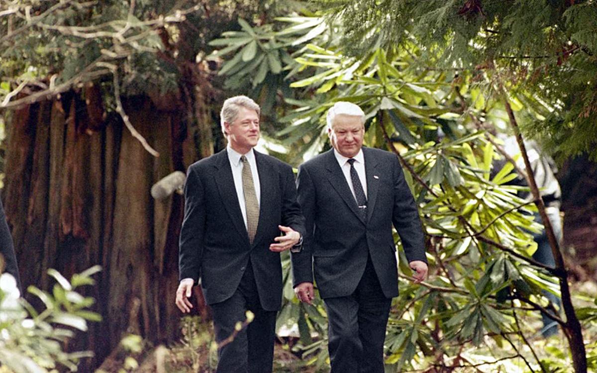 President Bill Clinton (left) and Russian President Boris Yeltsin take a walk through the woods near the Norman MacKenzie House at the University of British Columbia in Vancouver on April 3, 1993.