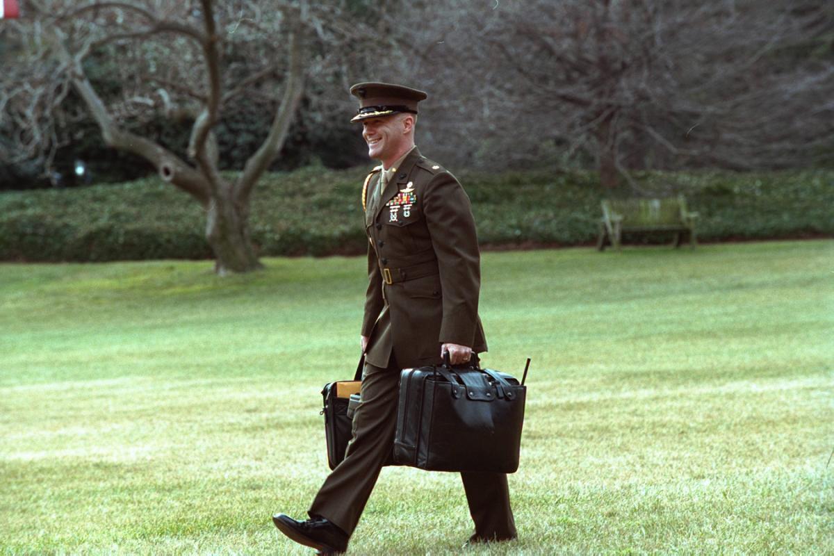 Military Aide Major Paul Montanus carries the Football to Marine One, deployed to the South Lawn, on January 20, 2002