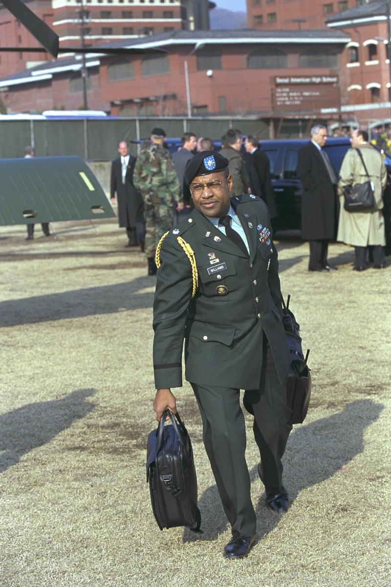 During meetings with South Korean President Kim Dae-Jung, President Bush visits the DMZ, 20 February 2002. Military Aide Chuck Williams carries the Football. Photo number P13625-22