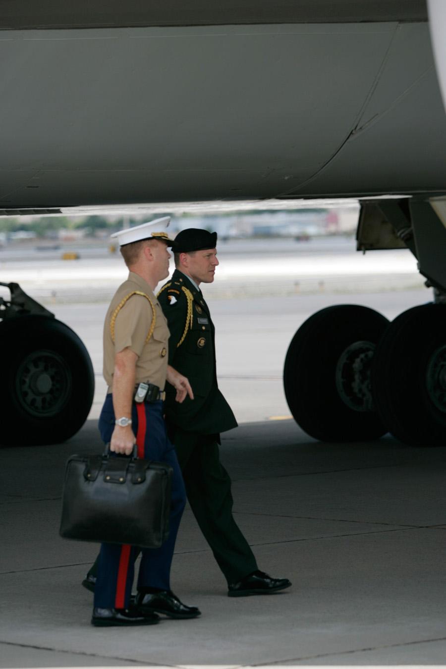 President Bush arrives at Reno/Tahoe International Airport, 18 June 2004, with Military Aide Major Christian Cabaniss carrying the Football and Military Aide Steve Fischer standing to his right