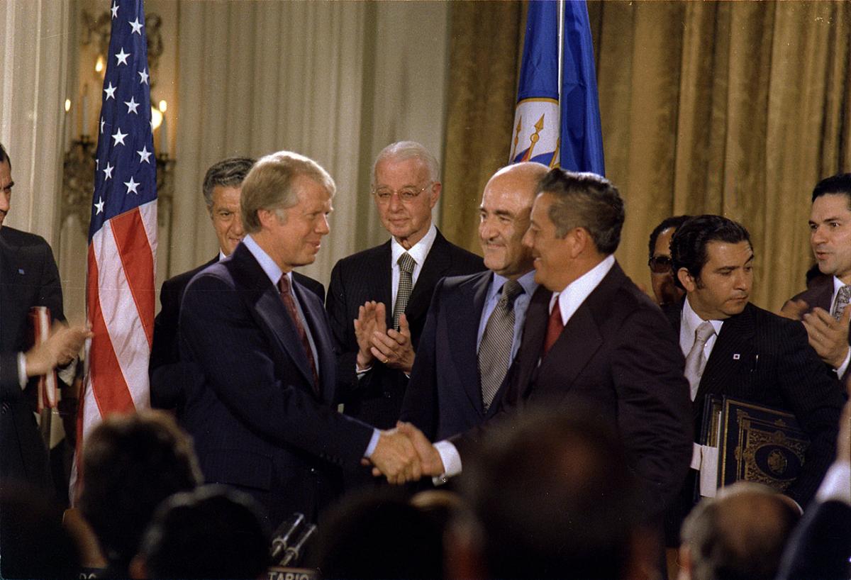 Jimmy Carter and General Omar Torrijos shake hands after signing the Panama Canal Treaty