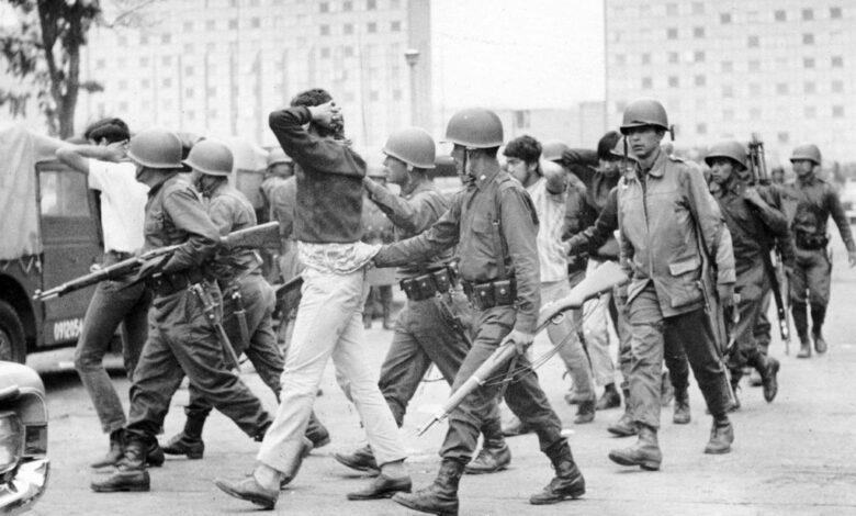 On Oct. 3 1968, army troops escort a group of young men from Mexico City's Plaza de las Tres Culturas, the scene of bloody clashes.