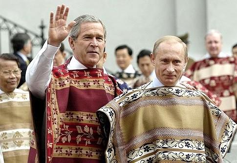 President Vladimir Putin and US President George W Bush wear Chilean ponchos as they arrive for an official APEC Leaders photo session at La Moneda palace. Santiago, Chile.