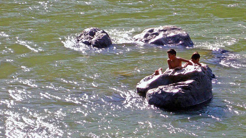 Two children from the Machiguenga village of Shimaa play in the nearby river