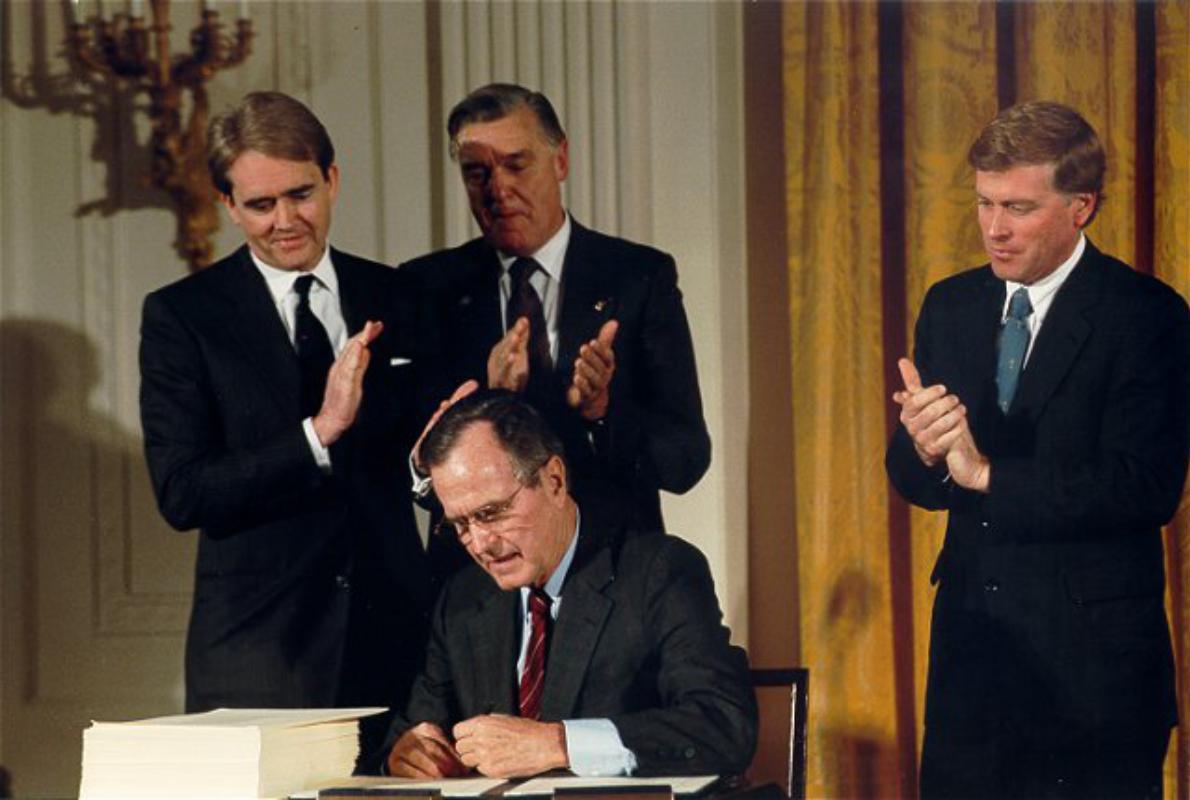 William Reilly watches as President George H. W. Bush signs the Clean Air Act Amendments
