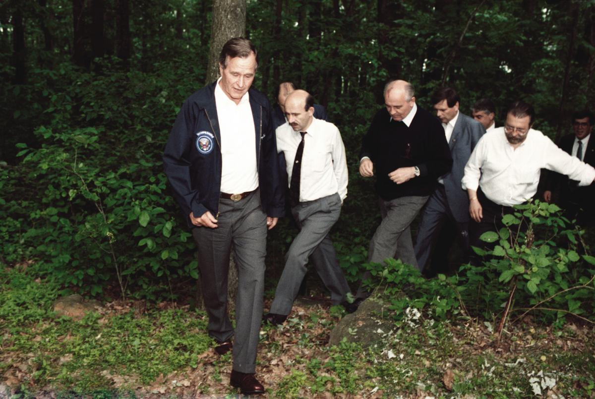 Bush, Gorbachev and а coterie of security agents in camp David woods