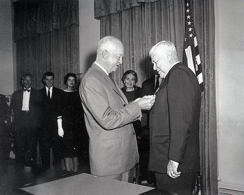 Secretary of Defense Charles Wilson receiving a medal from President Eisenhower
